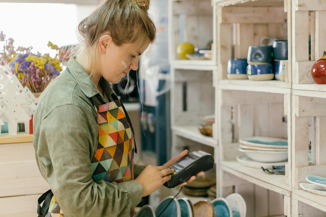 Retail employee using Shopify POS system to process sales—Stay ahead with 2025 Shopify updates for faster checkout & seamless store management.